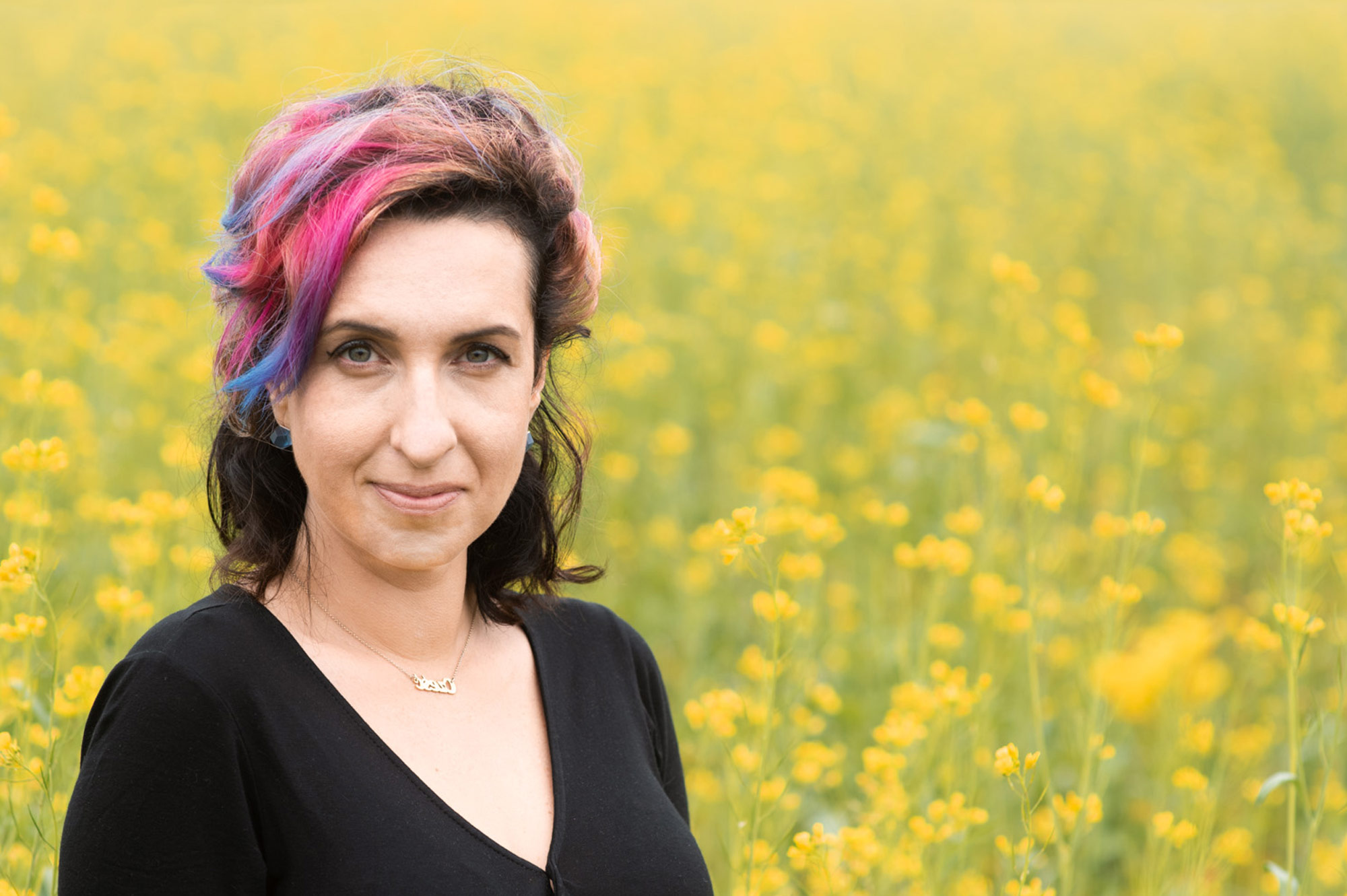 Sylwia Chutnik na tle łąki żółtych kwiatów